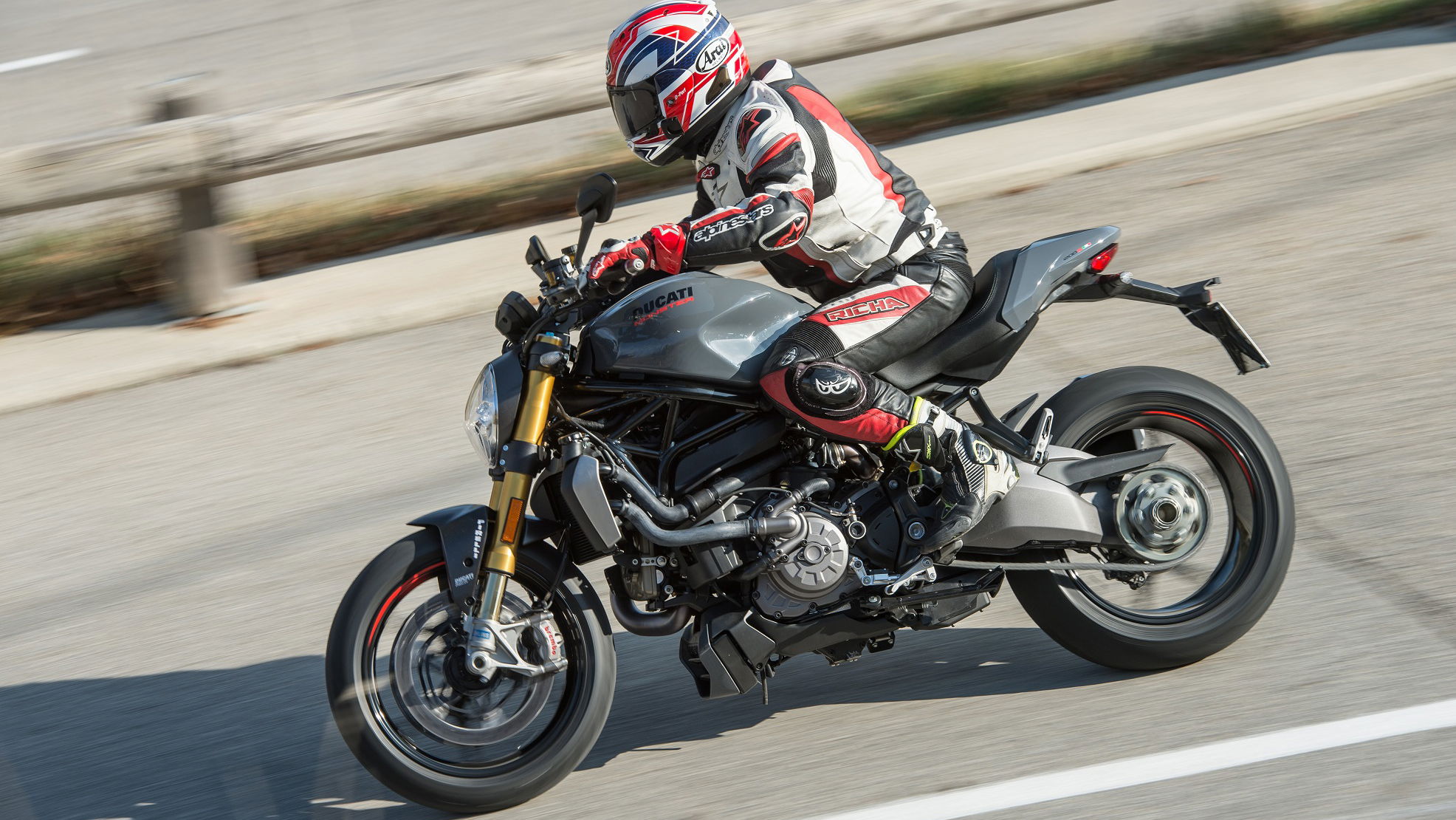 A grey and black 2017 Ducati Monster 1200S being ridden on a road